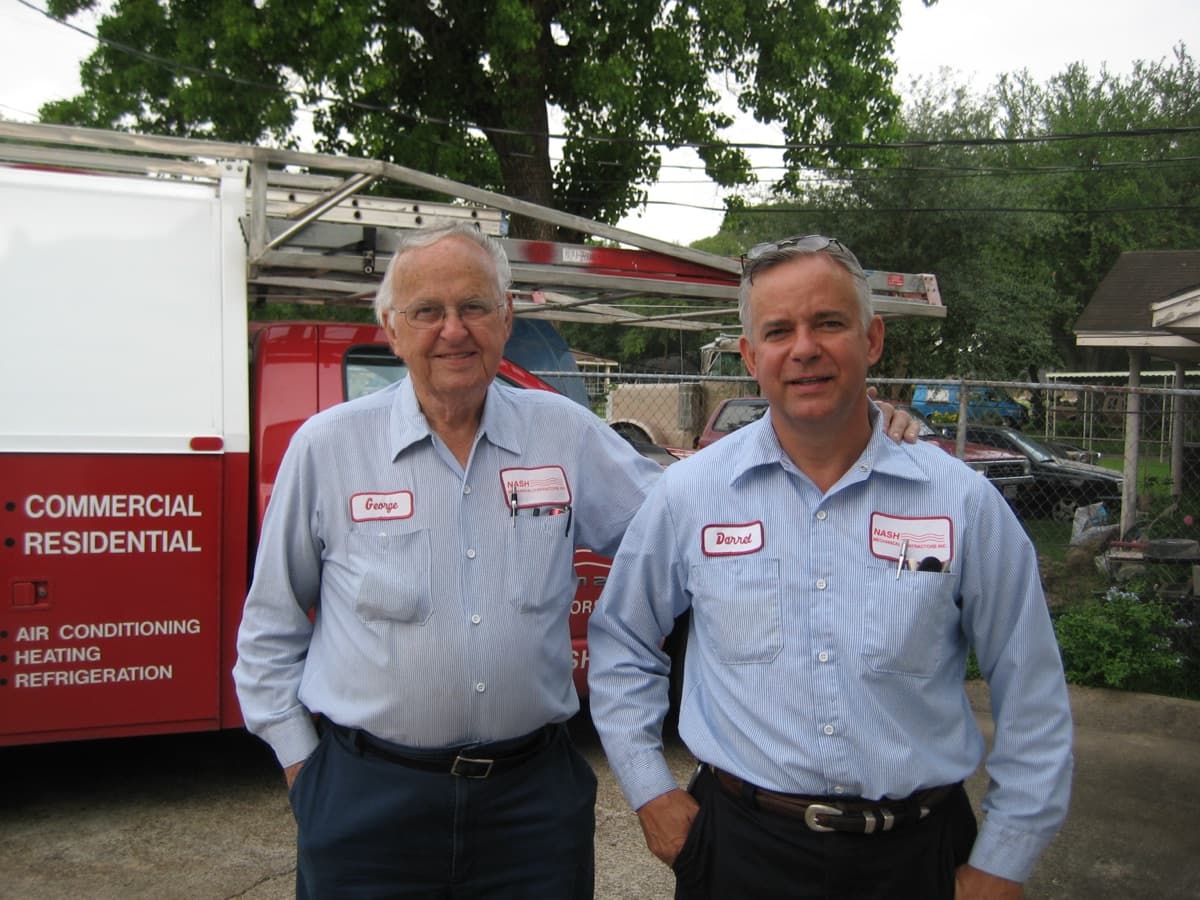 George and Darrel Nash in Nash Mechanical uniforms in front of a company truck